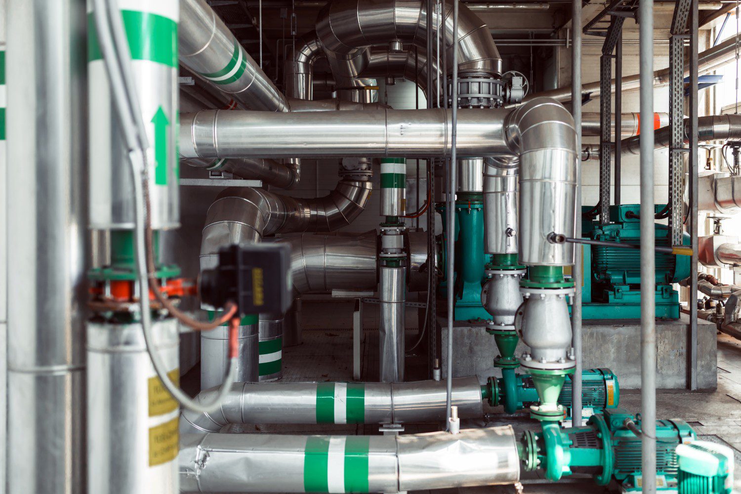 Industrial pipes and machinery in a facility.