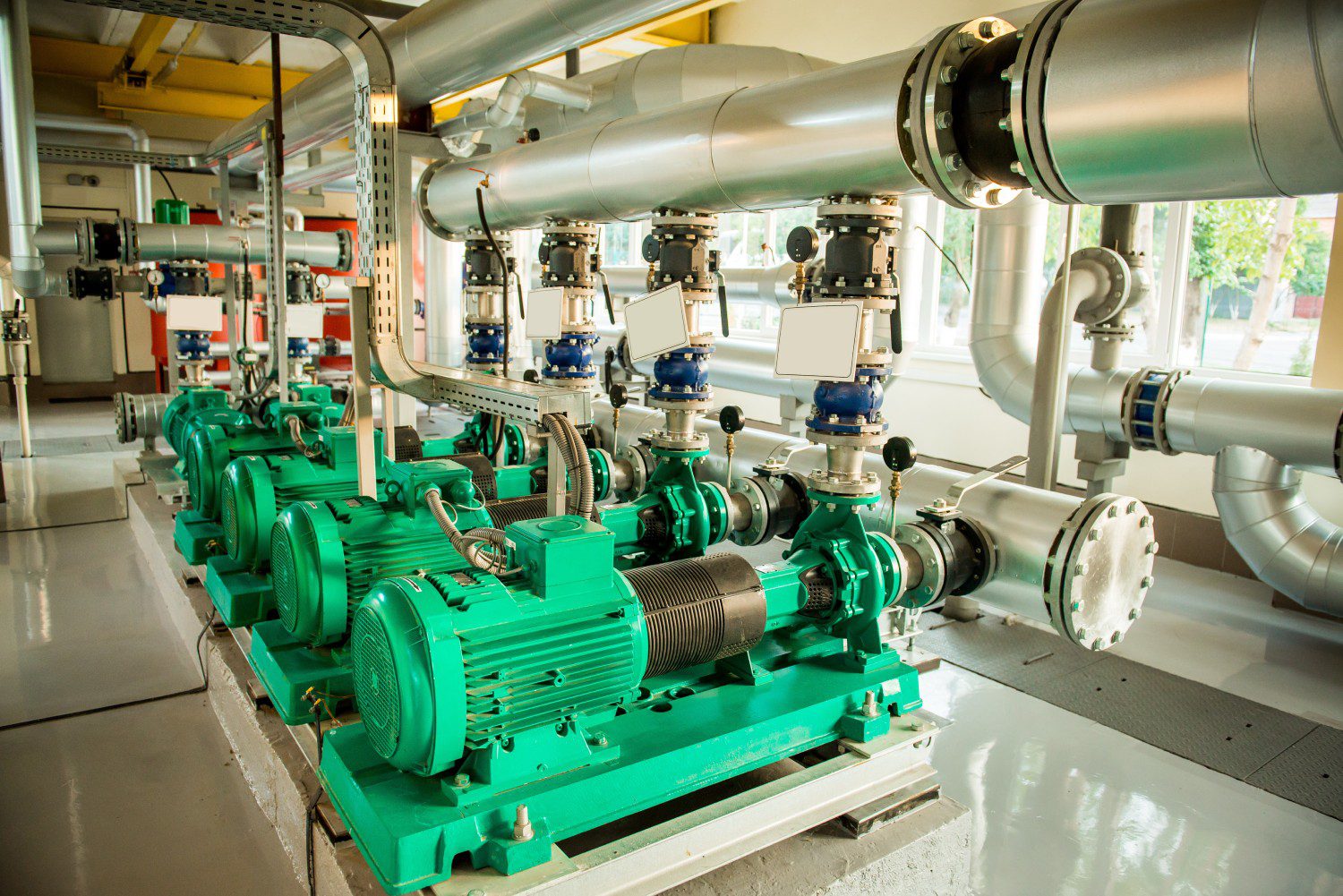 Industrial machinery with green motors and pipes.